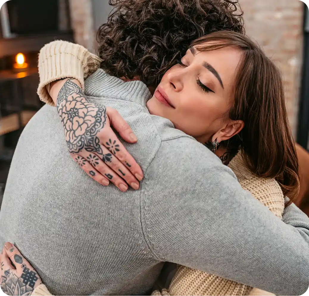Couple embracing warmly, showcasing emotional support and connection, relevant to addiction recovery and compassionate care at Charles River Recovery.